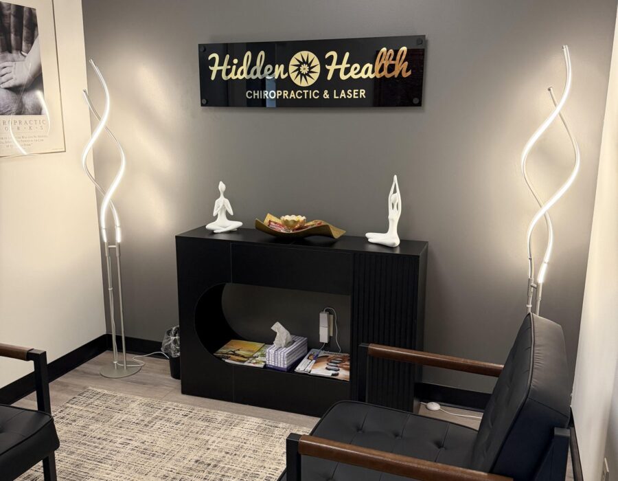Reception lounge with the Hidden Health sign and soft lighting