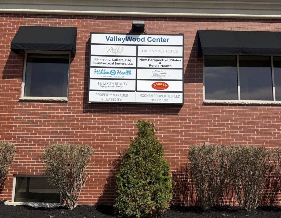 Valleywood Center building sign on Valley View Road listing Hidden Health Chiropractic